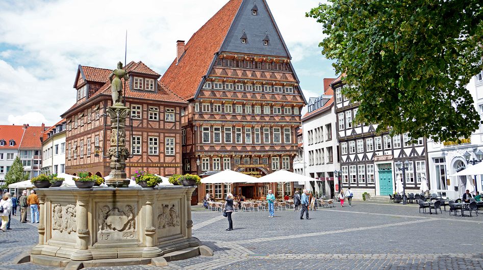 Historic buildings at a square in Hildesheim with a fountain in the foreground